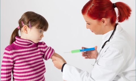 Doctor giving a childrens vaccines image