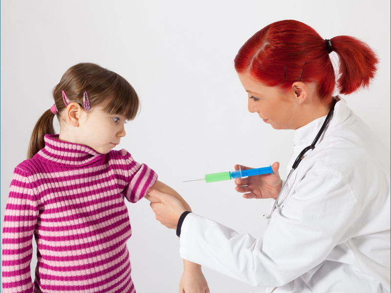 Doctor giving a childrens vaccines image